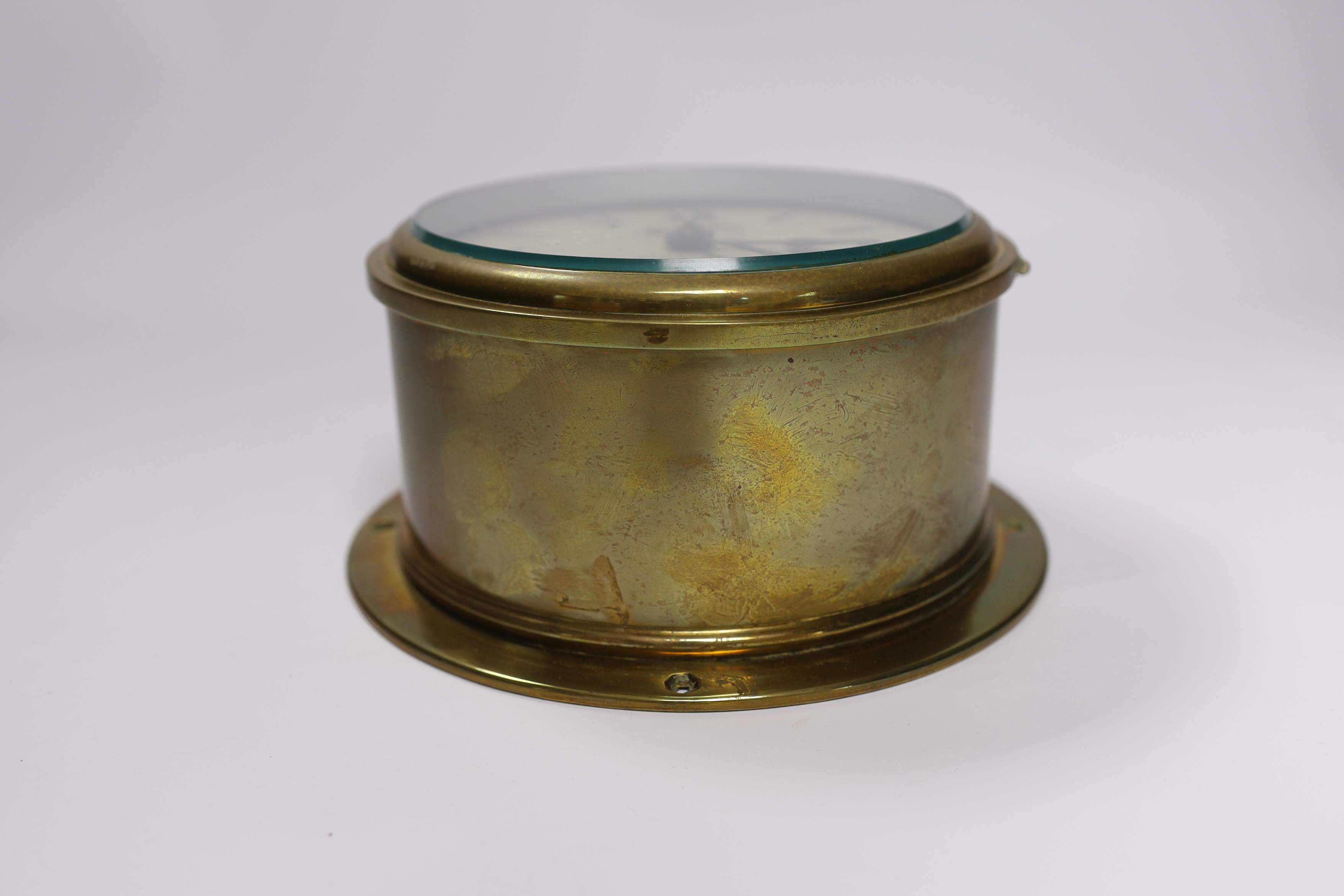 A brass ships bulkhead timepiece, by Smith & Chalmers, Southampton, base plate 19.5cm diameter